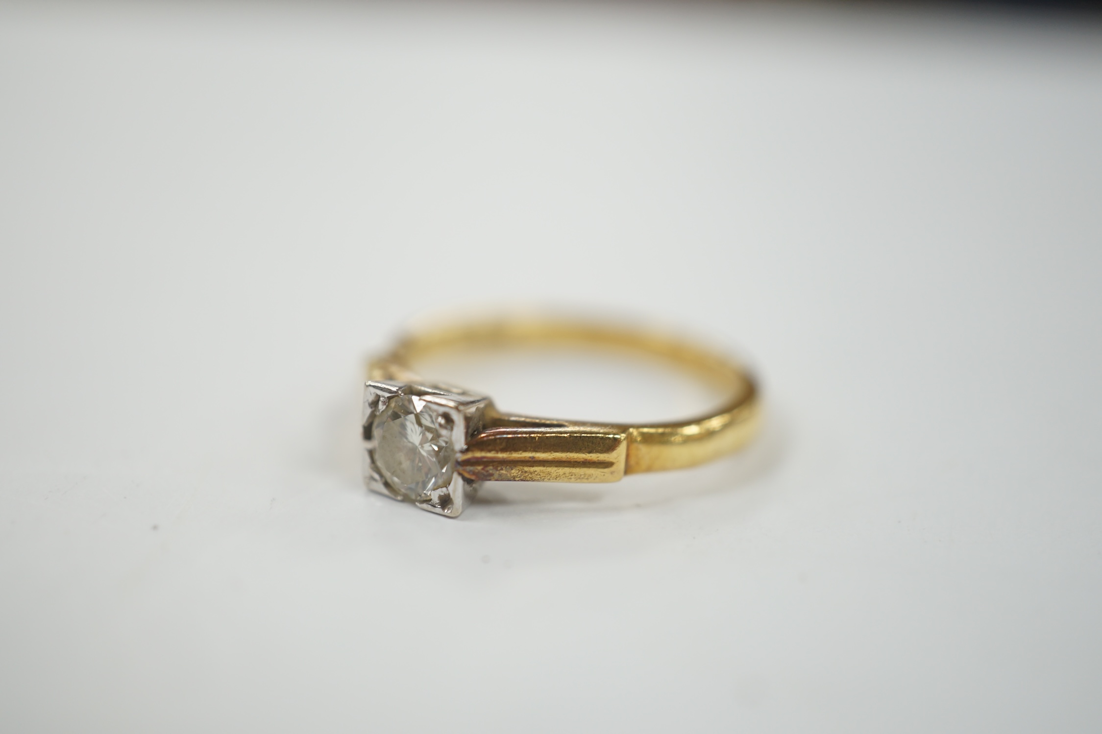 A modern 18ct gold and solitaire diamond set ring, size N, gross weight 3.6 grams.